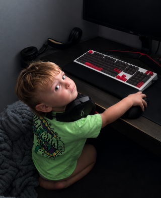 My son reaching for the keyboard at my desk